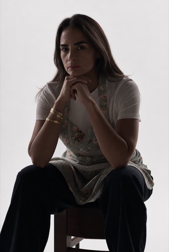 Betty seated, restyled into a moody cinematic portrait with soft directional light.