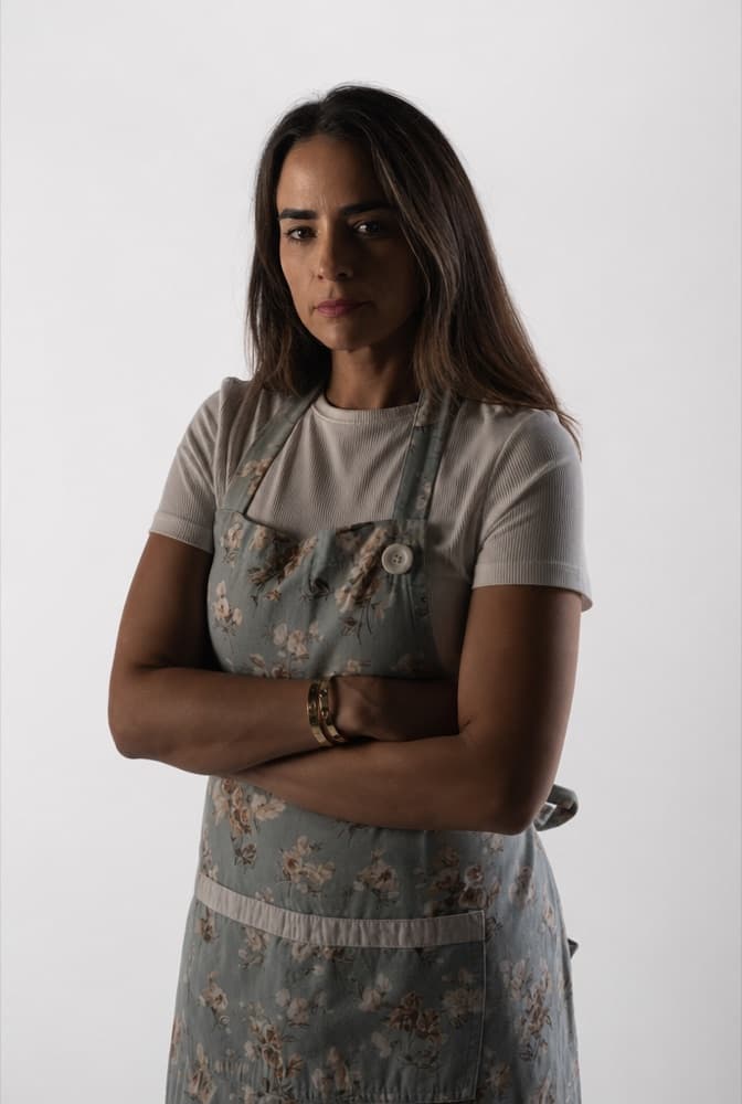 Betty restyled into a clean studio portrait, arms crossed, serious expression.
